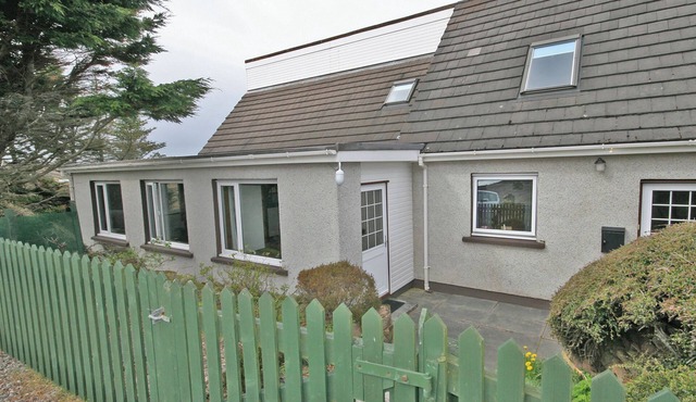 Overlooking the sweeping sandy bay of Opinan on the stunning west Highland coast .