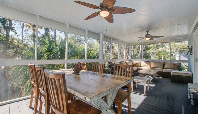 Palm-surrounded abode with screened-in balcony, chef's kitchen, smart TVs, & W/D