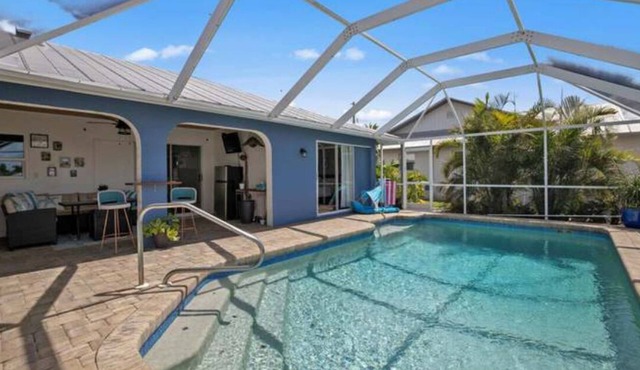 Paradise Awaits. Beautiful Home with Pool located on a canal with dock