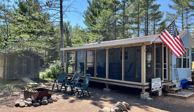 Parkmodel cabin w screened porch in campground on bike trail.