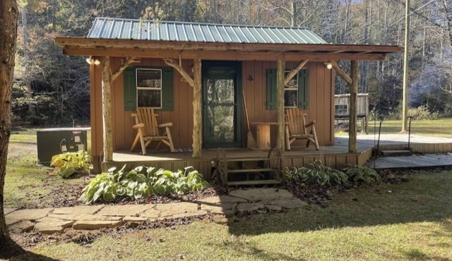 Peaceful cabin in secluded mountain spot beside a picturesque creek