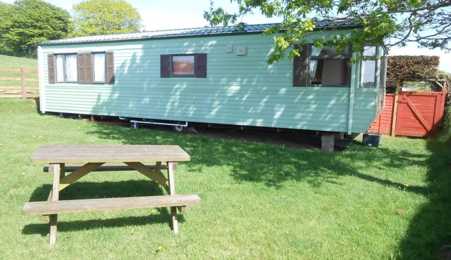Peaceful caravan with WiFi in charming outskirts Callington on a working farm .