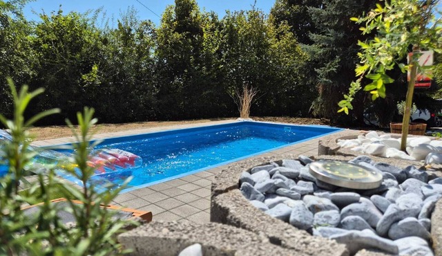 Peaceful forest home with spa, pool, and space for family and pets.
