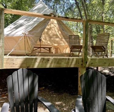 Peaceful Glamping Tents with Elevated Decks, Cozy Fire Pit, and Secluded Forest Views Near Gentry, AR