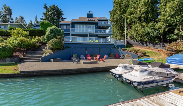 Peaceful lakefront home with firepit, hot tub, pool table, dock, balcony, & deck