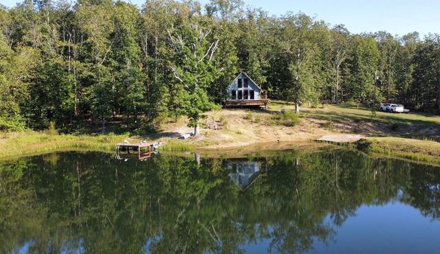 Peaceful secluded cabin nestled on 40 wooded acres overlooking 4 acre pond.