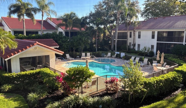 Pelican Bay Condo overlooking pool and gardens, with private beach access.