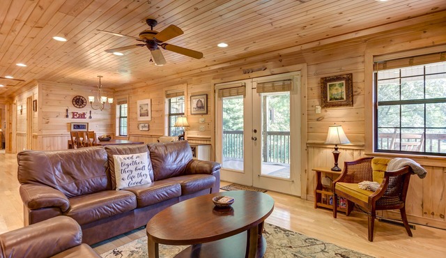 Pond-front cabin with private hot tub, fireplaces, furnished deck, & game room
