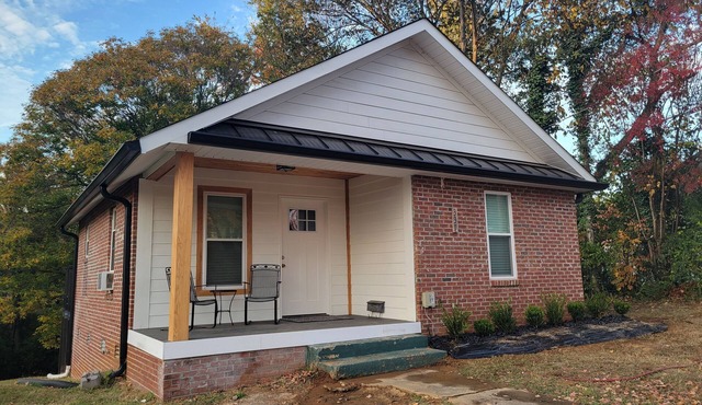 Pristine creekside home in peaceful Maryville with sprawling yard and deck.