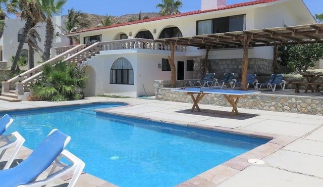 Private beachfront pool, airy & open living area leading to an outdoor oasis