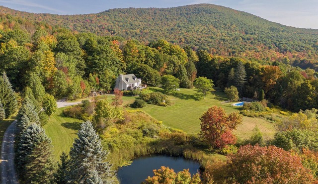 Private Contemporary Cottage with heated pool, hot tub and wide mountain views.