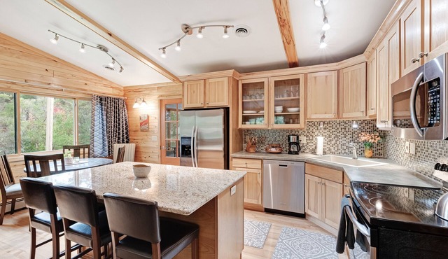 Private lakefront home with boat dock, fireplace, & generous yard