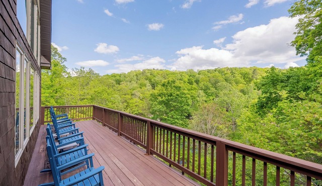Private lakefront home with dock, forest views, balconies, game room, and cozy indoor charm