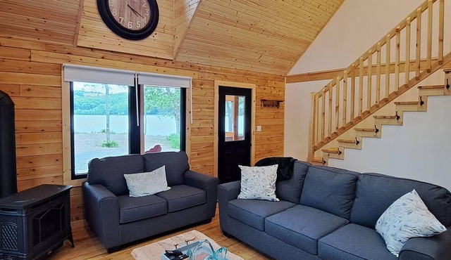 Private lakefront log cabin with year-round hot tub.