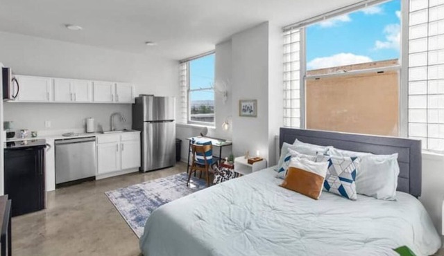 Private loft with rooftop deck, fitness center, and private parking.