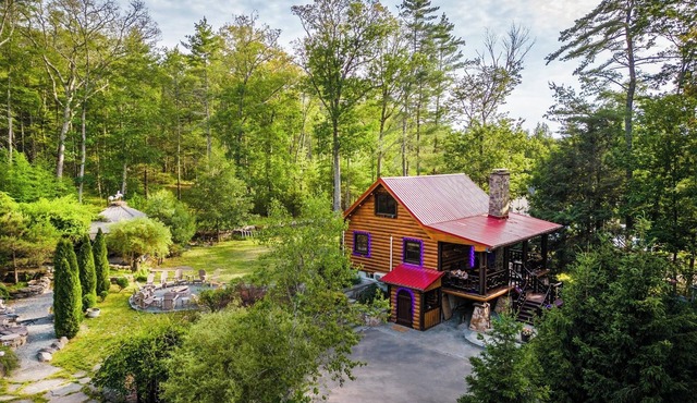 Private log cabin nestled at the base of a secluded wooded area n