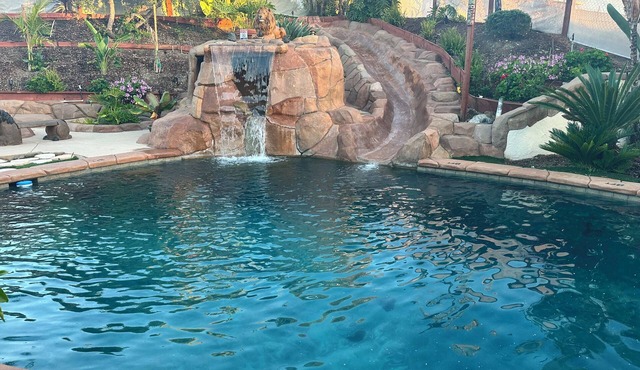 Private oasis in backyard, beach entry solar heated pool, jacuzzi & water slide