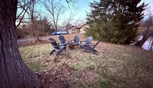Private one-bedroom suite with king bed, walk-in closet, and ensuite bath featuring double vanity and safety grab bars. Enjoy serene pond views from your patio, full kitchen, and dedicated workspace for a comfortable stay.