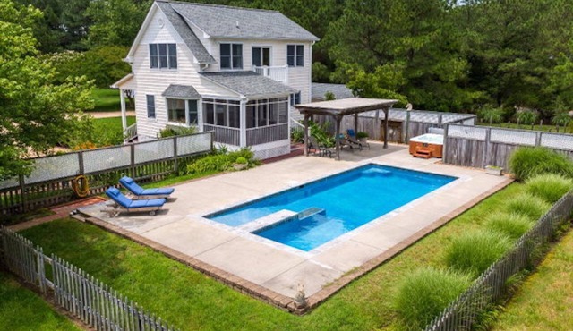 Private, secluded waterfront cottage - pool and hot tub feet from the back door.