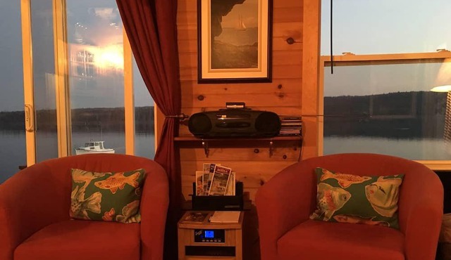 Private self contained cottage with terraced decking right to the water.