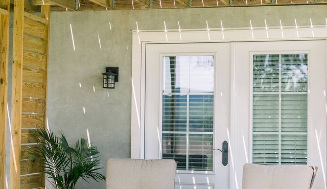 Private suite with kitchenette, bedroom, bathroom and patio.