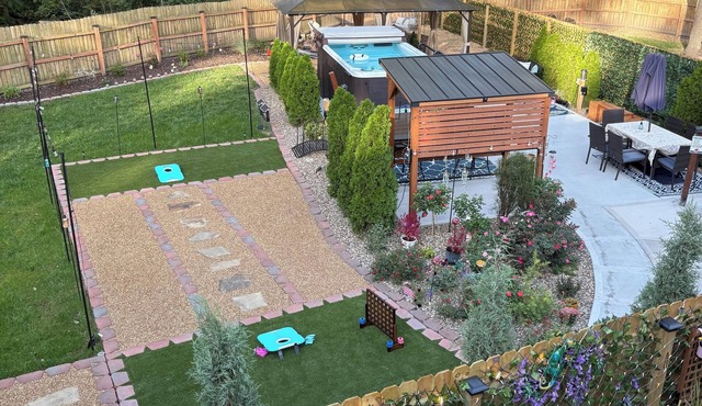 Private Urban Oasis with heated pool spa, outdoor bar and TV, firepit, corn hole