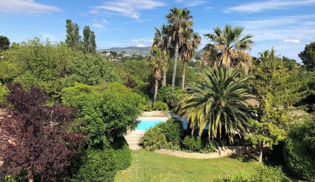 Property with swimming pool, garden and sports field.