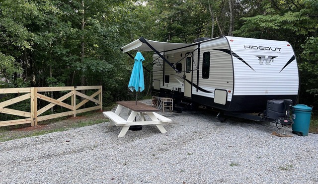 Quaint camper in a private area with full hook ups!
