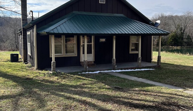 Quaint farm house with a small fishing pond.