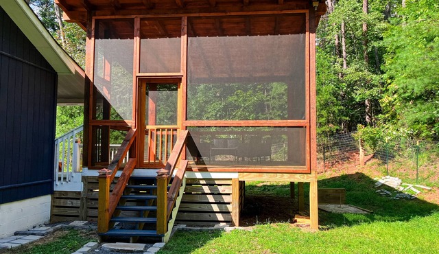 Quaint wooded escape with wraparound deck, firepit, & fast WiFi - dog-friendly