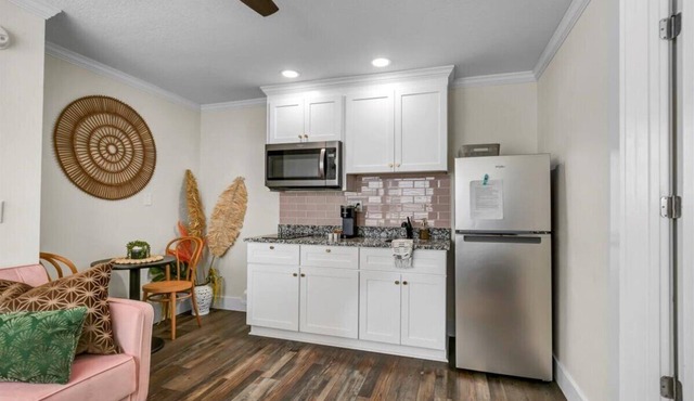 Queen bed, kitchenette, living room/couch.