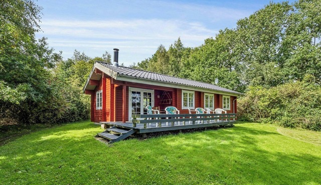 Red timber house with fjord view