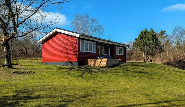 Red wooden house with spa near Knudeklinterne