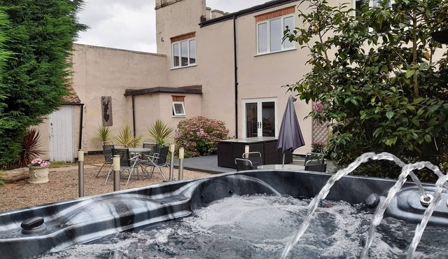 Relax and unwind at our hot tub retreat, close to activities, trails, water park