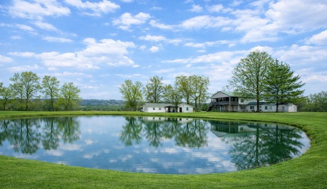 Relax at this peaceful two home countryside retreat with a private hot tub, pond views, 2 fire pits, and fishing for cozy comfort and country charm for everyone.