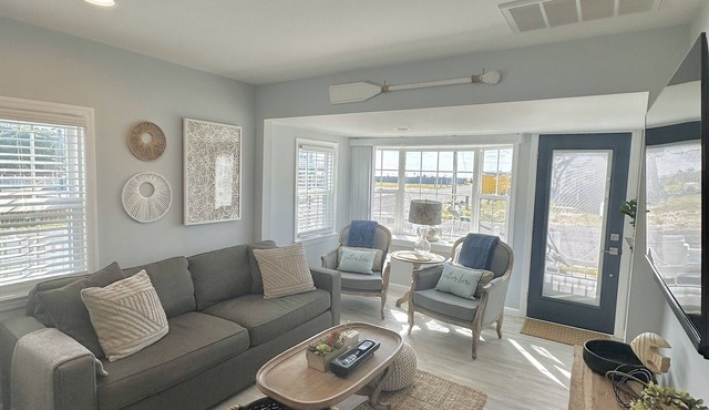 Relax here with beach views, steps to the beach, fenced in yard, pet friendly