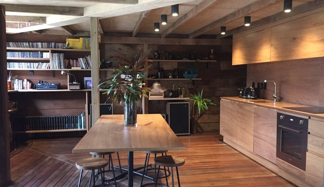 Relax in our Muriwai Sanctuary amongst the trees.