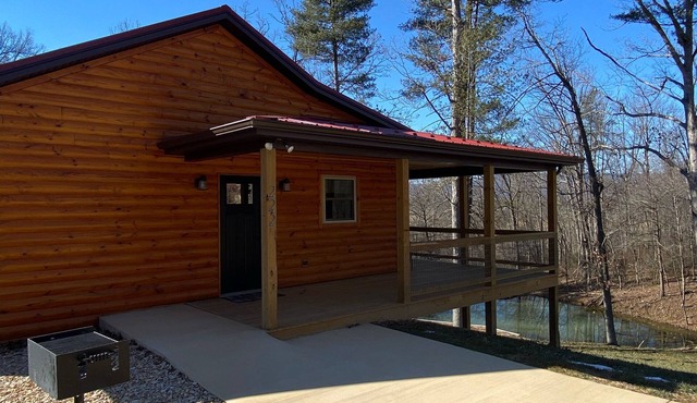 Relax in our secluded hot tub overlooking the pond with a glass of wine in Luray