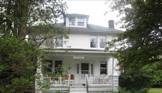 Relax on the covered front porch at "Allegheny" in Eagles Mere