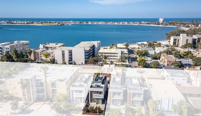 Relax, recharge and enjoy panoramic sunset views over the bay and ocean in this luxurious home