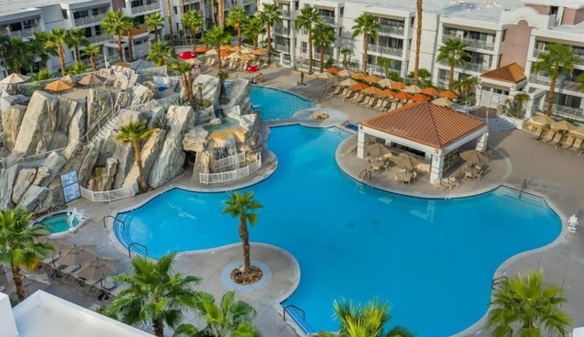 Relax with Stunning Pool Views from Your Private Balcony in This Modern Suite