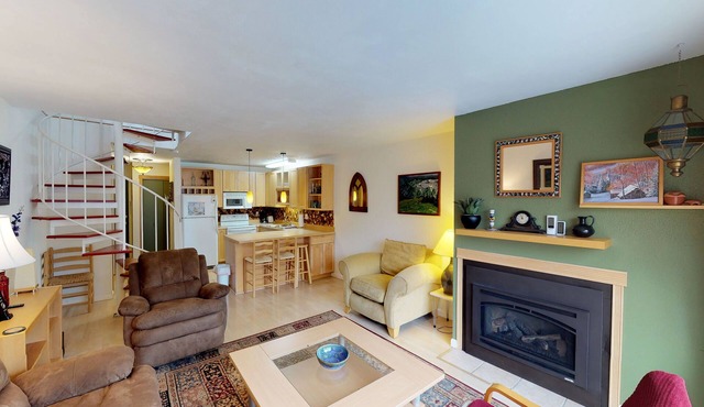 Renovated condo with mountain views, fireplace & spiral staircase - walk to lift