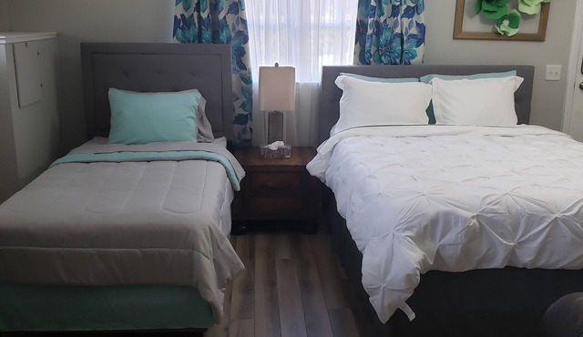 Renovated Suite with 1 queen bed and a Twin. Kitchen & bath for your privacy.