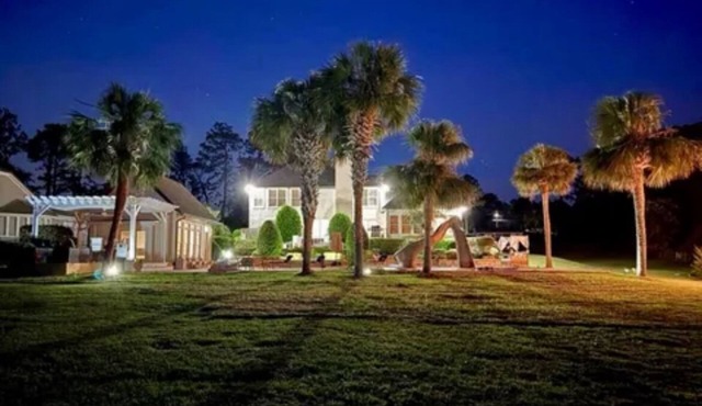 Resort style 5-bedroom lake house with white sand beach, pool, and pool house.