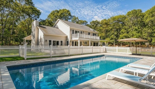 Resort-style Southampton retreat with heated pool, chic interiors, and.