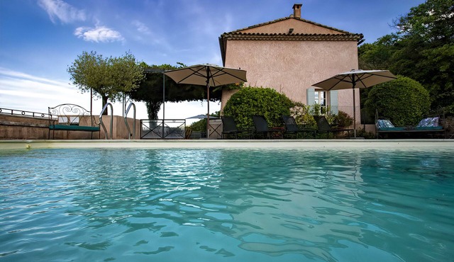 Restored farmhouse with heated pool and landscaped gardens.