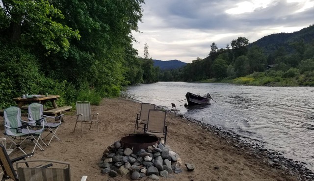 RIVER LIFE ON A WARM SANDY BEACH ON THE RIVER NEXT TO DOWNTOWN ROGUE RIVER.
