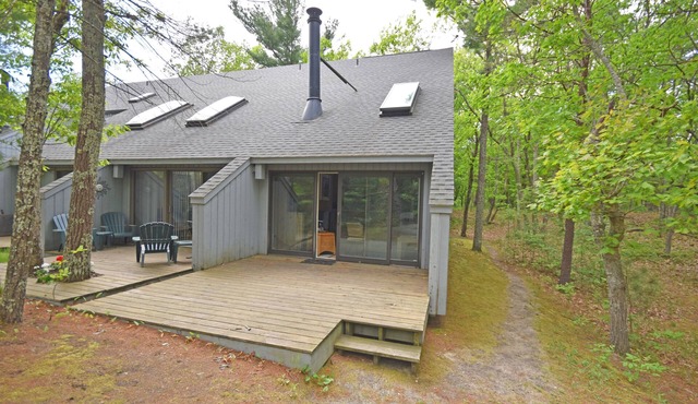 Riverfront condo with water views, deck, fireplace, W/D, and community firepit