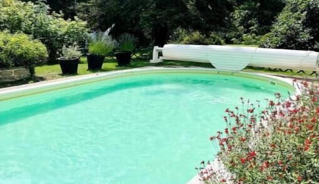 Riverfront pool and sauna house in a flower-filled park