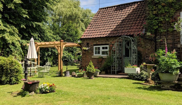 Riverside cottage in a beautiful garden in Lincolnshire.